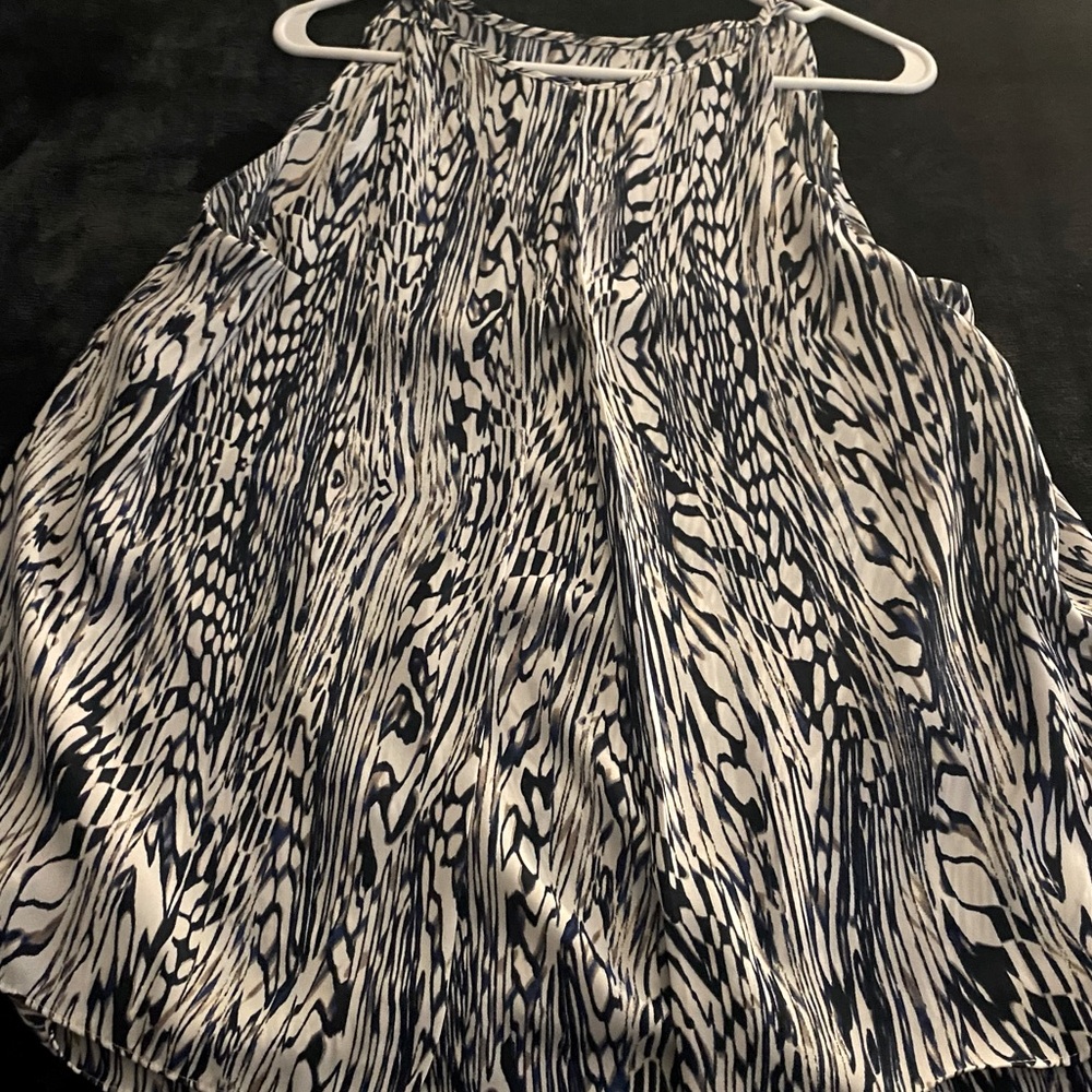 Woman’s sleeveless swing A-line blouse. Zip back